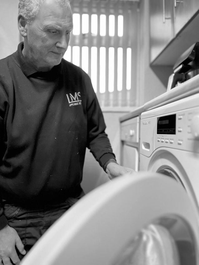 LMS Appliance Repairs engineer working on a washing machine in a Bristol home
